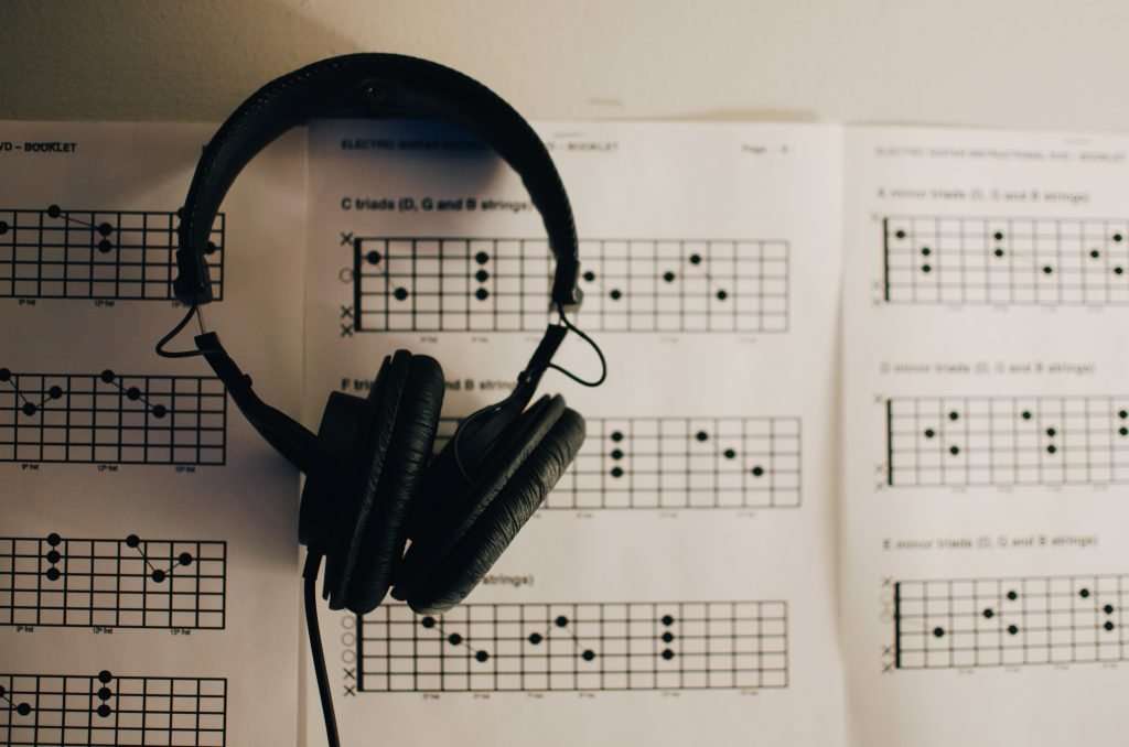 Picture of headphones & TAB paper - useful items to use with your discount guitar courses